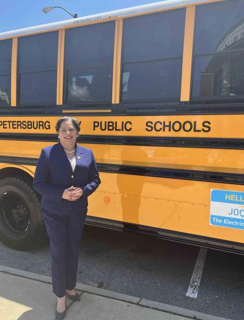Rep. McClellan stands in front of Petersburg City Public School bus