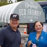 McClellan stands next to a man in front of an electric ice cream truck. 