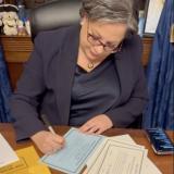 Photo of Rep. McClellan signing the oath of office for the 119th Congress.