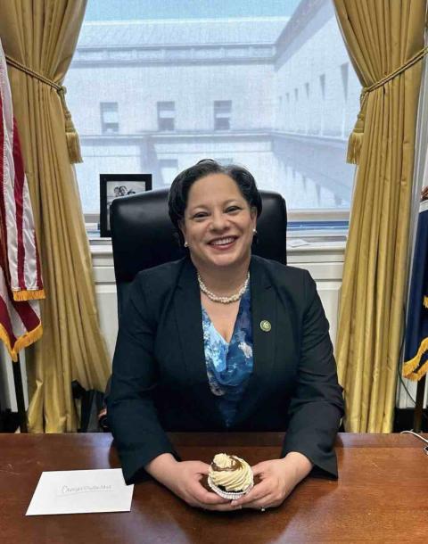 Rep, McClellan holds a cupcake at her desk