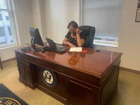 Rep. McClellan sits at her desk on the phone for her Tele Town Hall