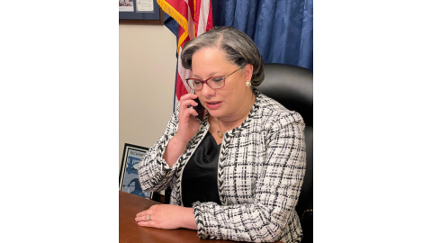 Photo of Rep. McClellan at her desk speaking on her phone for the tele-town hall.