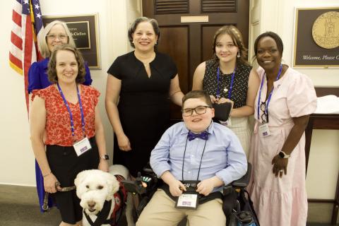 Photo of Rep. McClellan with Ben Bumgarner, his family, and Medicaid advocates.