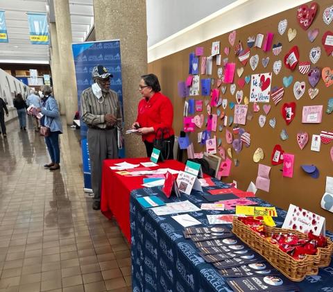 Photo of Rep. McClellan speaking with a veteran at her 2024 Valentines for Veterans event.