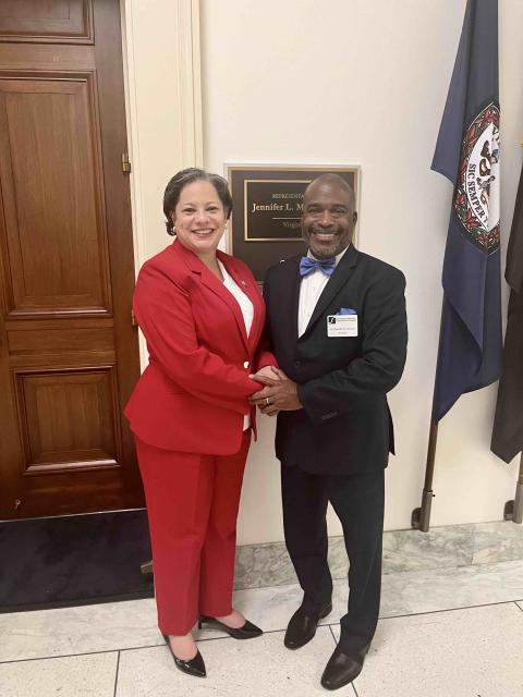 Rep. McClellan stands next to President Quentin Johnson in front of her Washington office
